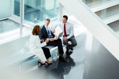 Financial Advisor holding a virtual whiteboard of charts and words about saving.